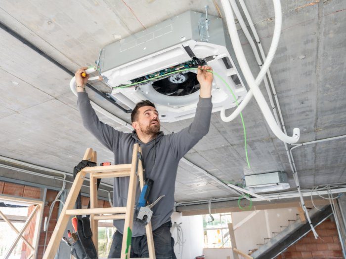 Professional air duct cleaning in Huntsville AL — certified HVAC technician cleaning residential duct system
